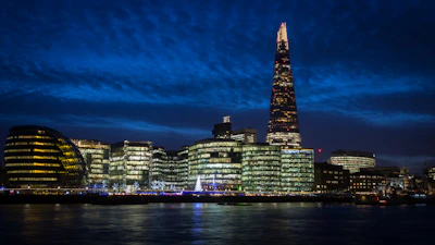 A striking night view of London's iconic financial district with illuminated skyscrapers.
