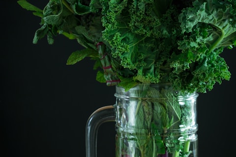 green vegetables on clear glass pitcher