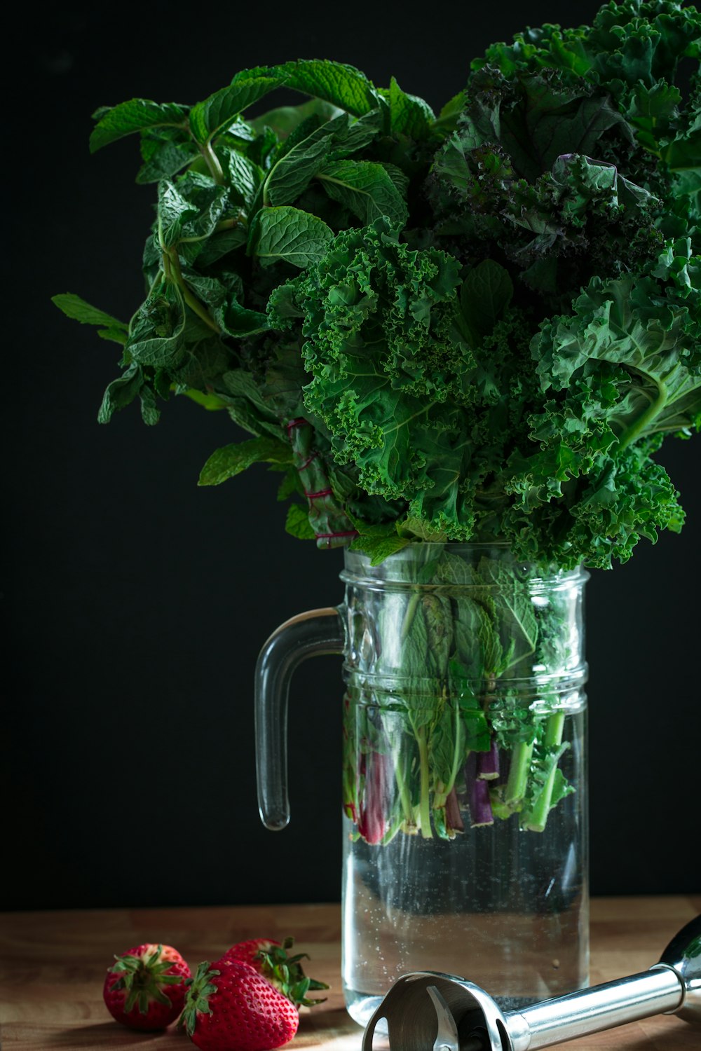 green vegetables on clear glass pitcher