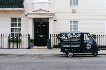 black autographed parked near white concrete building