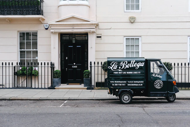 A delivery truck branded with Alema SRL logo departing the logistics center.