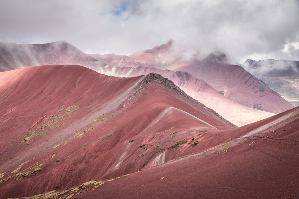 brown mountain surrounded with clouds