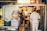 Photo of a busy restaurant kitchen with staff unpacking supplies efficiently.