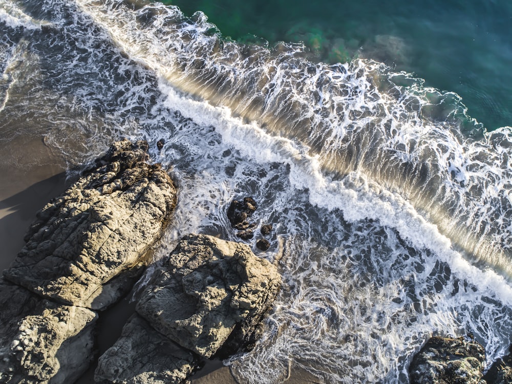 aerial view of rock formation beside body of water