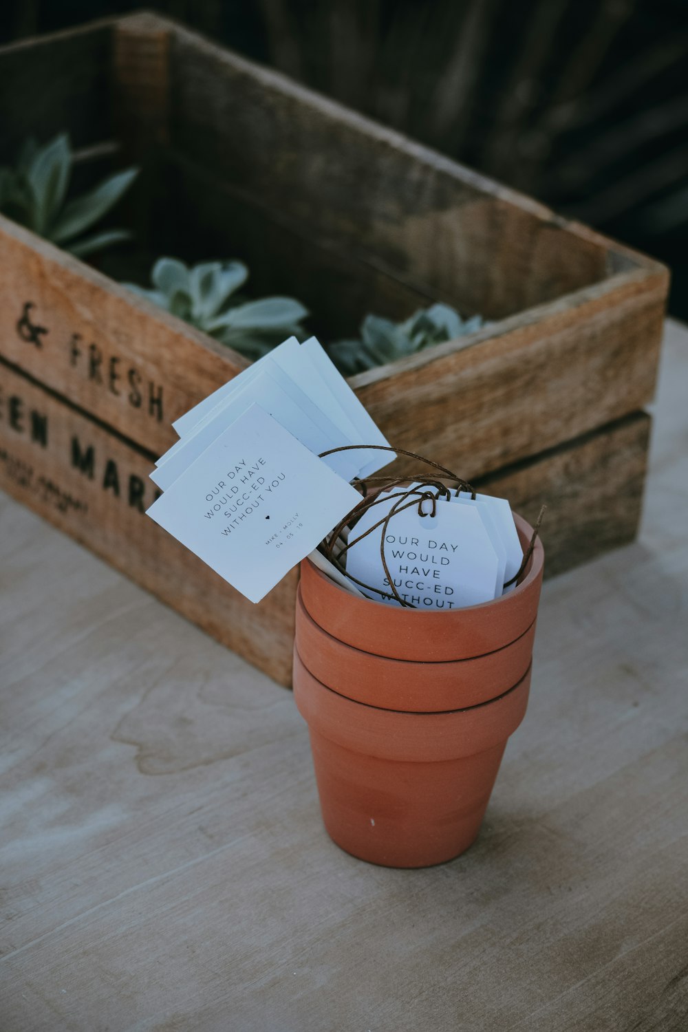 three piled brown clay pots near crate