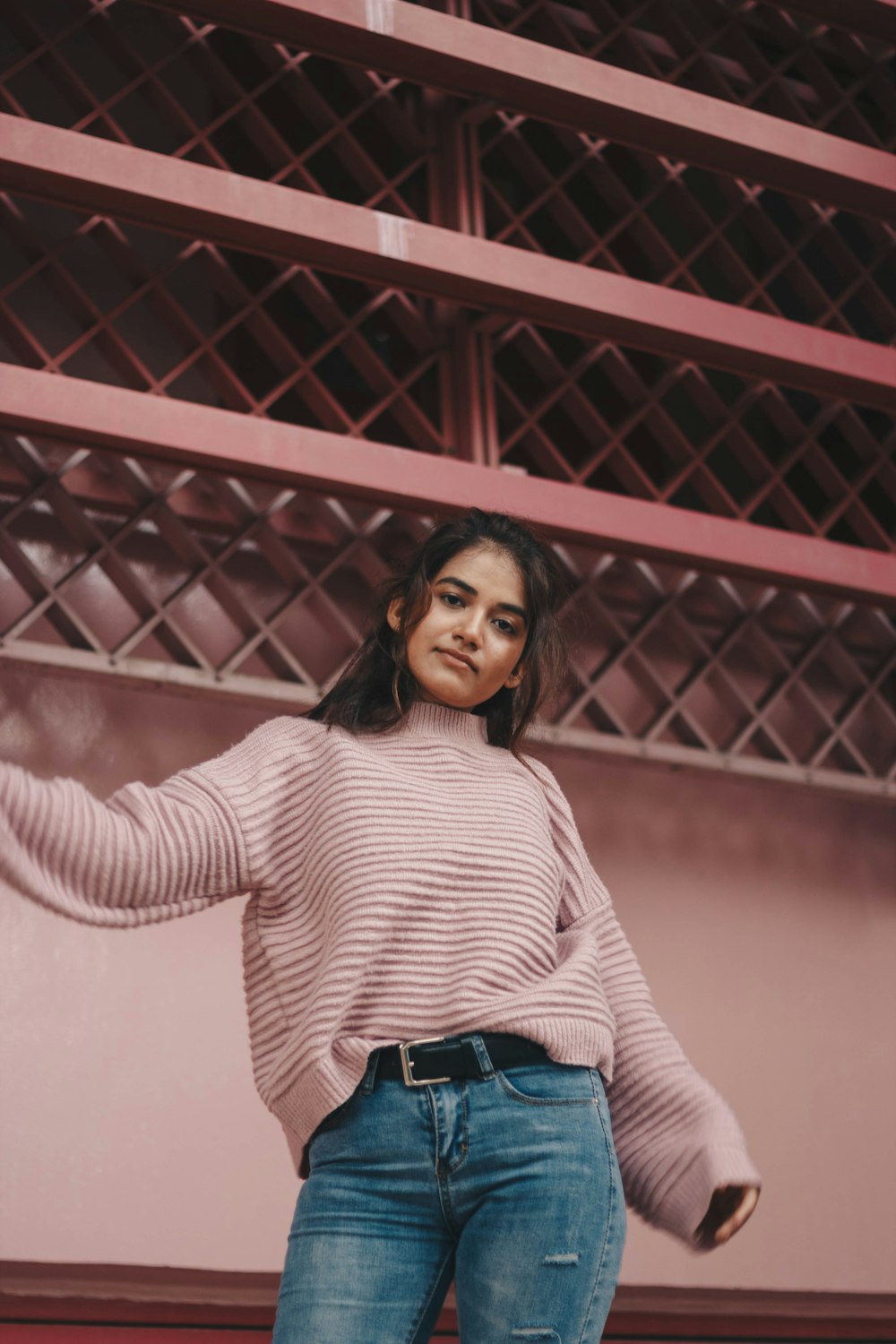 photo of woman standing beside wall