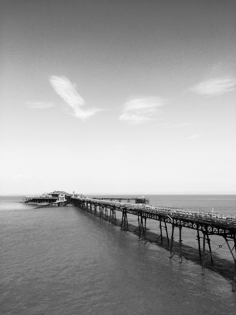 grayscale photo of wooden dock on body of water