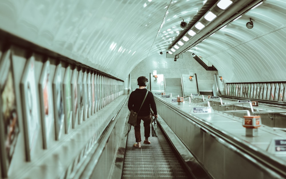 person walking on escalator