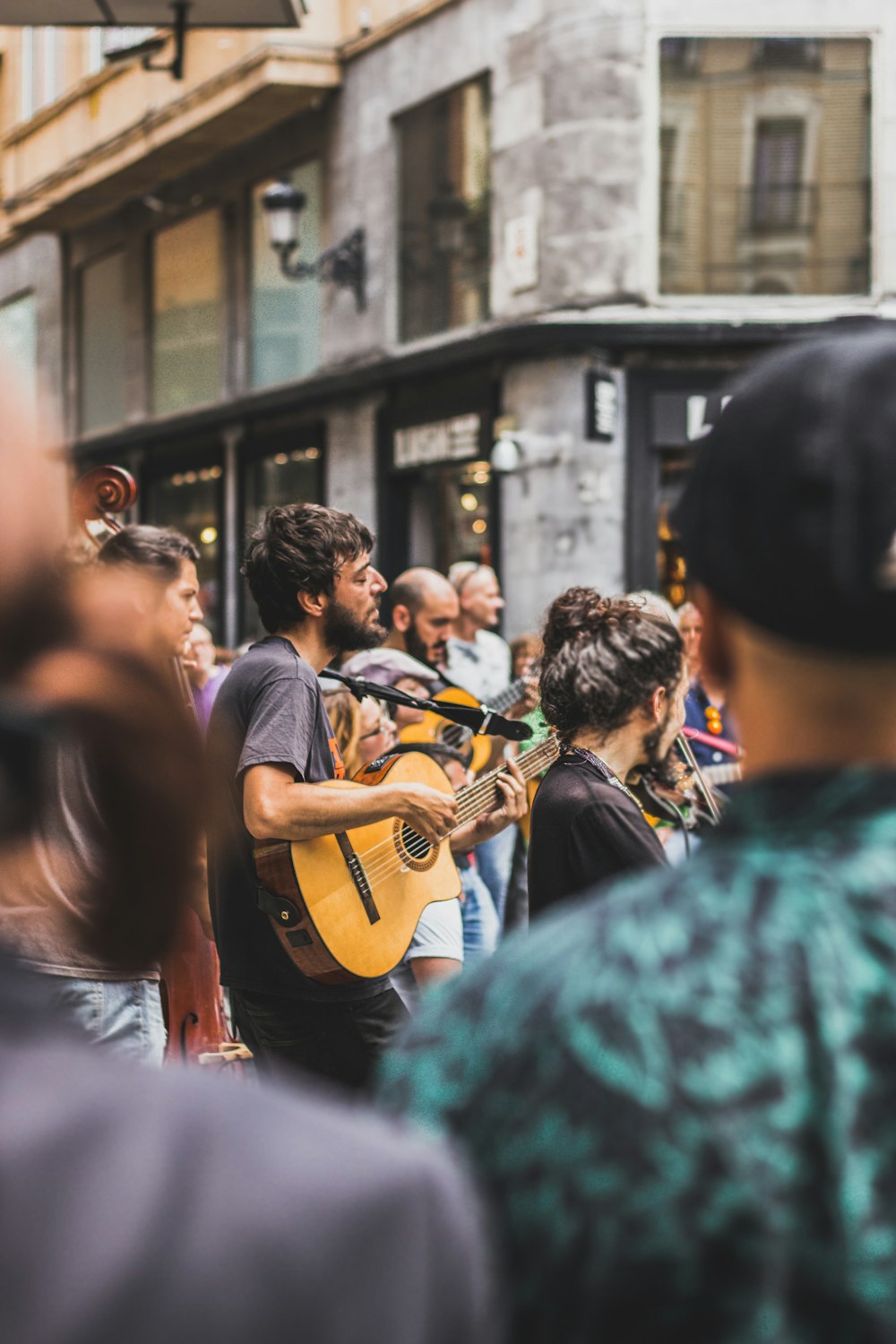 tilt shift photography of man playing guitar