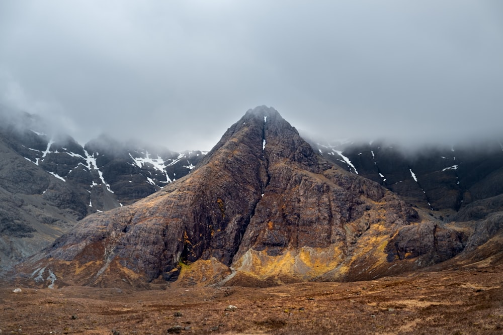 brown mountain on cloudy day