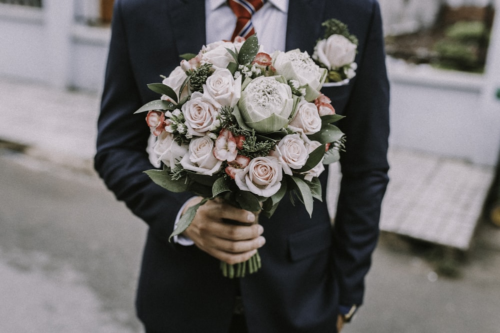 man holding a rose bouquet