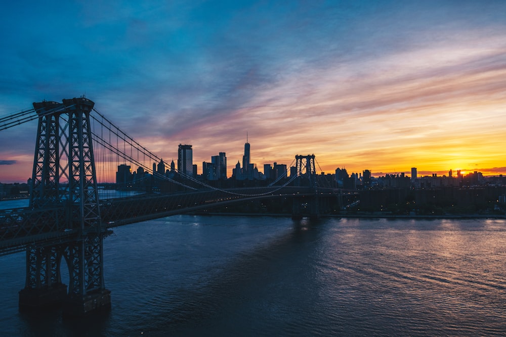 suspension bridge under cloudy sky