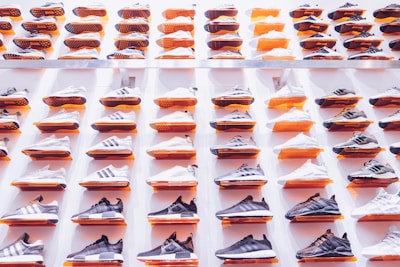 A stylish display of various sneakers arranged on a minimalist shelf.