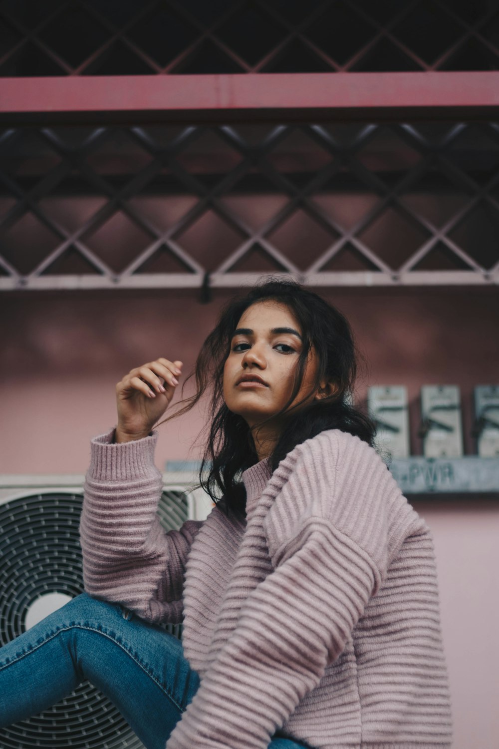 woman taking picture while sitting on chair