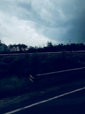 A freight truck driving along a highway with containers.