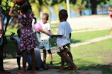 A group of kids playing outdoors, all dressed comfortably in laisvėja’s sensory-friendly clothes.