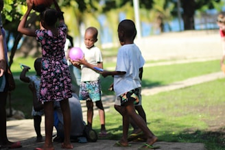A group of kids in a playground, dribbling colorful basketballs designed for early education.