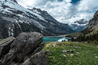 body of water surrounded by mountains during daytime