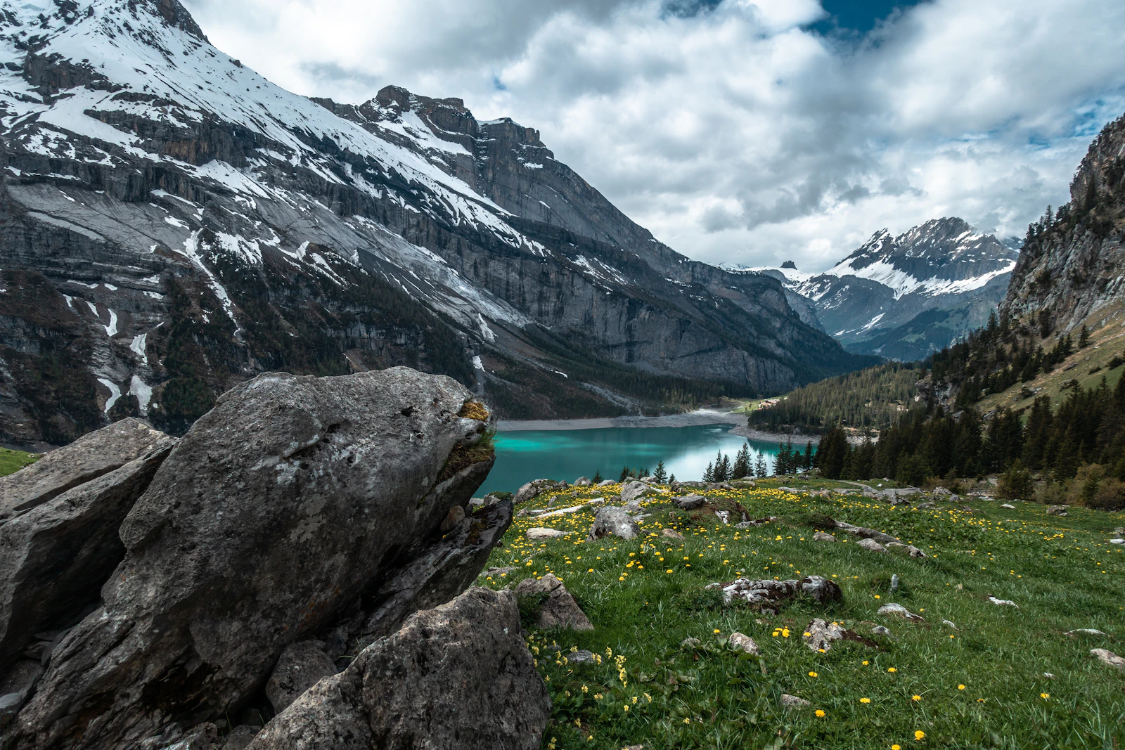 Lac de montagne entouré de sommets alpins (image d'illustration)