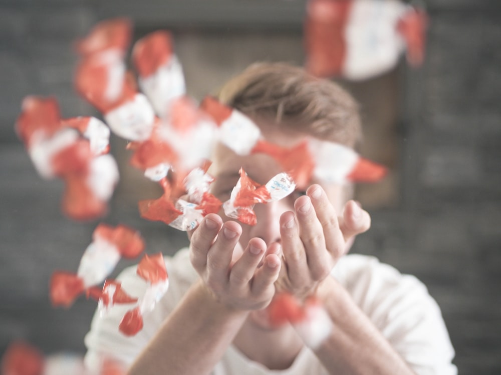 man scattering flower petals