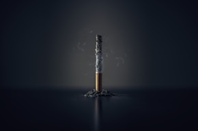 single cigarette stick with ashes stick
