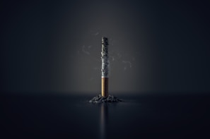 single cigarette stick with ashes stick