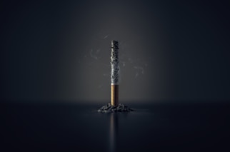 single cigarette stick with ashes stick