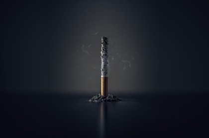 single cigarette stick with ashes stick