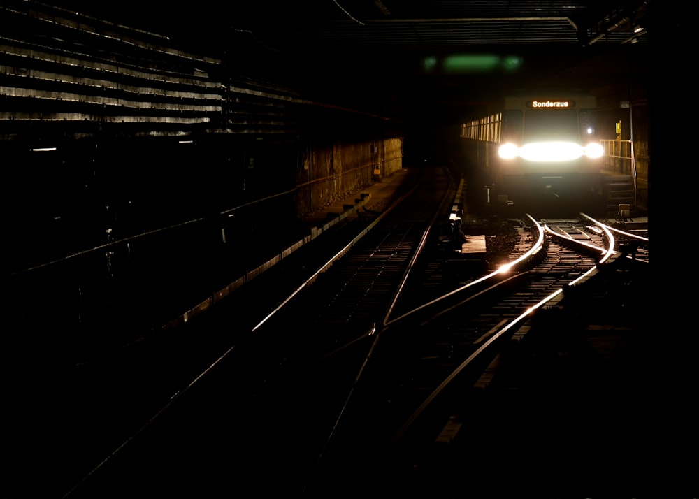 a train traveling down train tracks at night