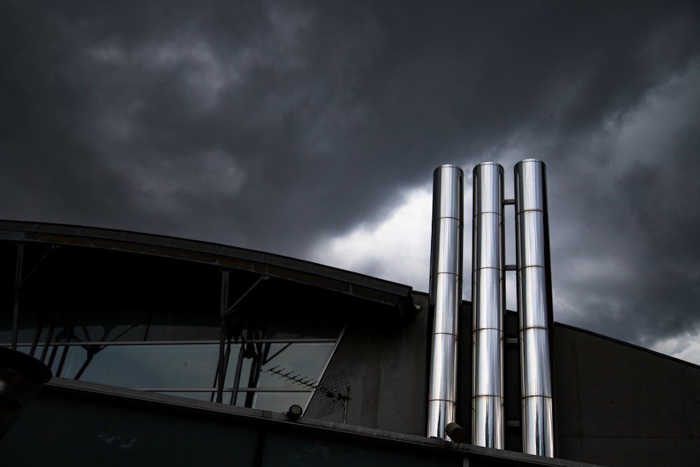 stainless steel tanks on gray cloudy sky