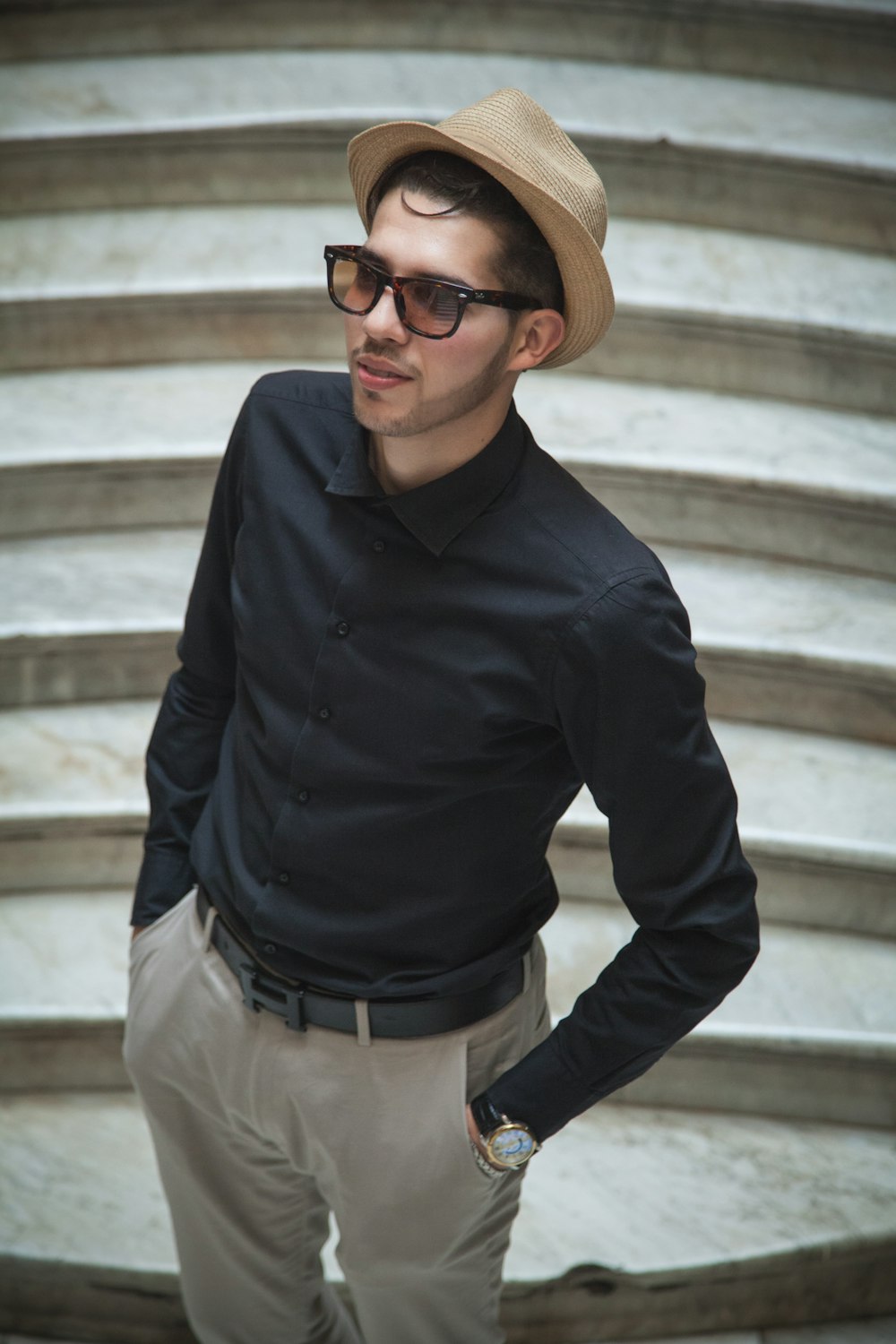 man standing on gray stairs