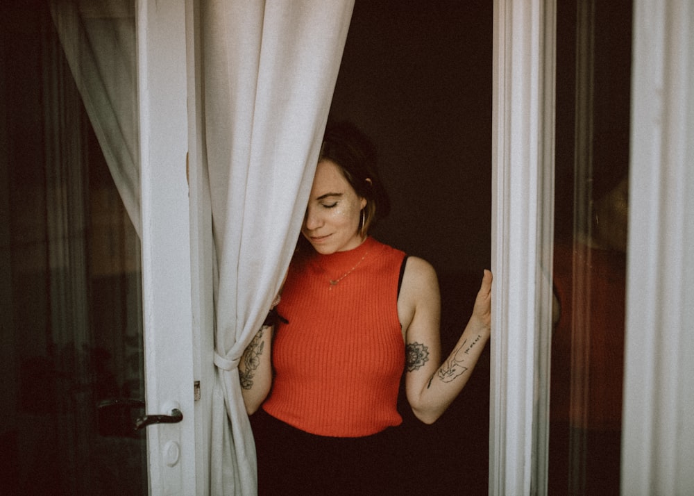 woman standing on glass door