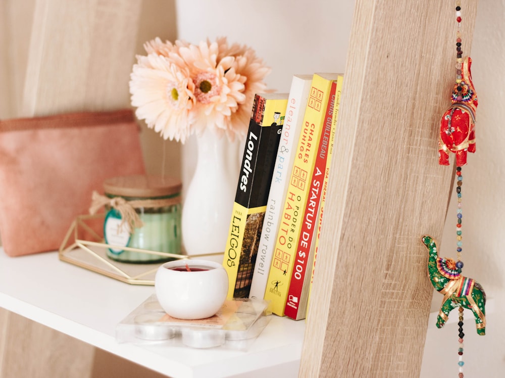 photo of book and candle on shelf