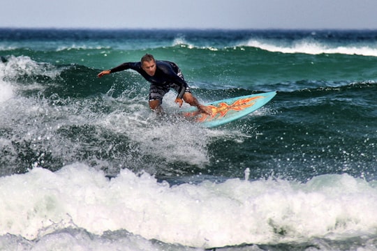 man riding a surfboard during daytime in Biarritz France