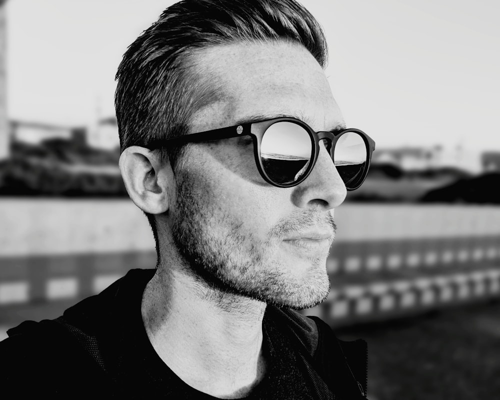 grayscale photography of man wearing sunglasses