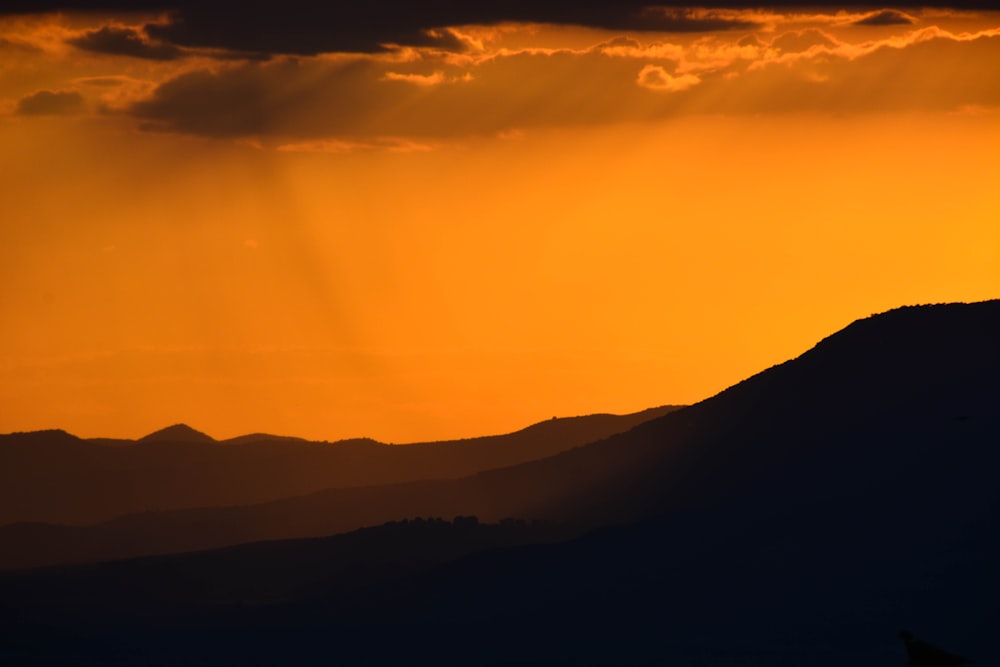 photo of mountains during sunset