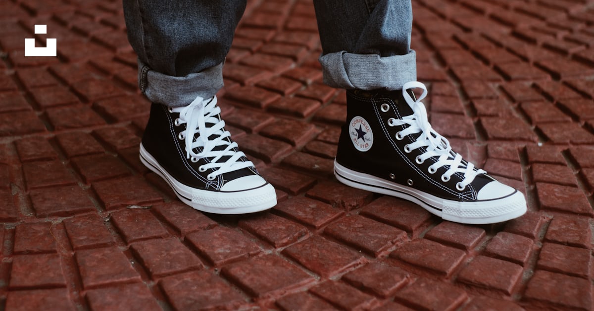 Person showing pair of Converse All-Star high tops photo – Free Sneaker ...