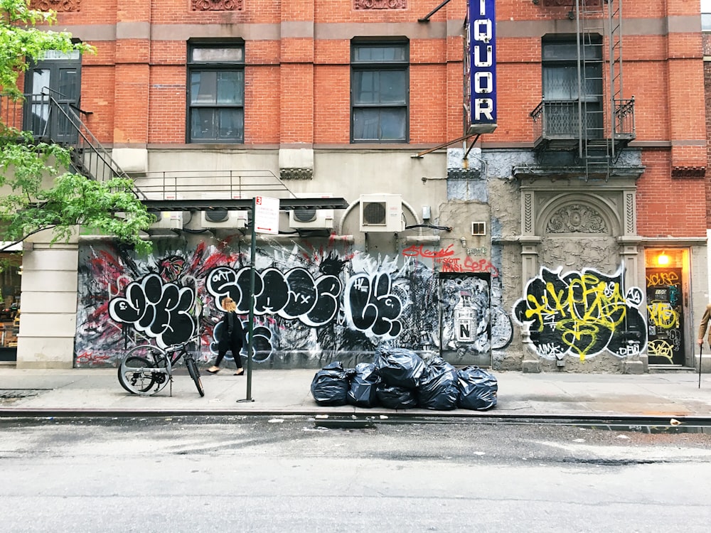 man standing near calligraphy wall