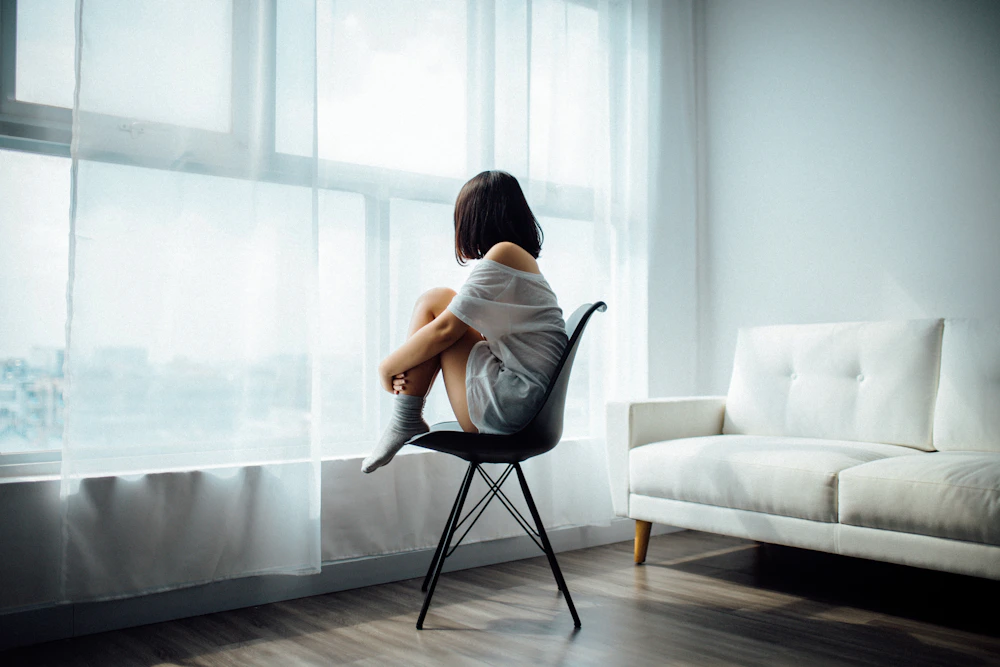 Person sitting quietly by a window