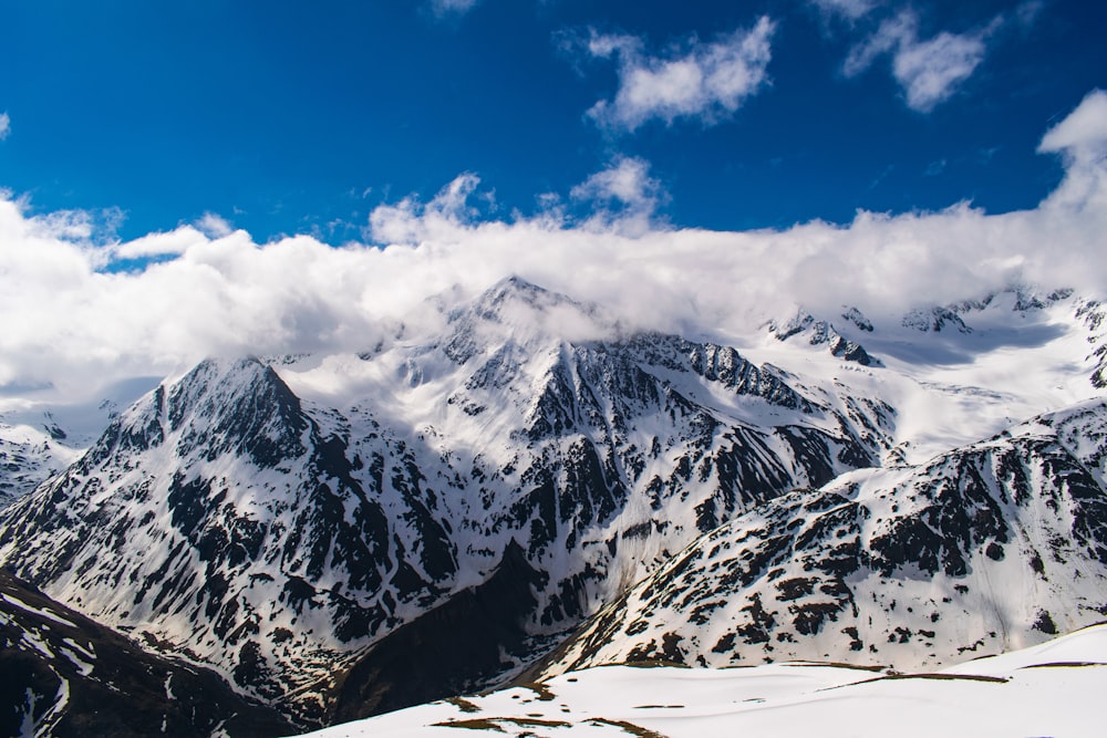 snow covered mountains under white sky at daytime