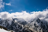 Mountain peaks dusted with snow under a clear blue sky.