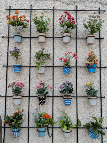 A beautifully arranged display of decorative flower pots and artificial flowers.