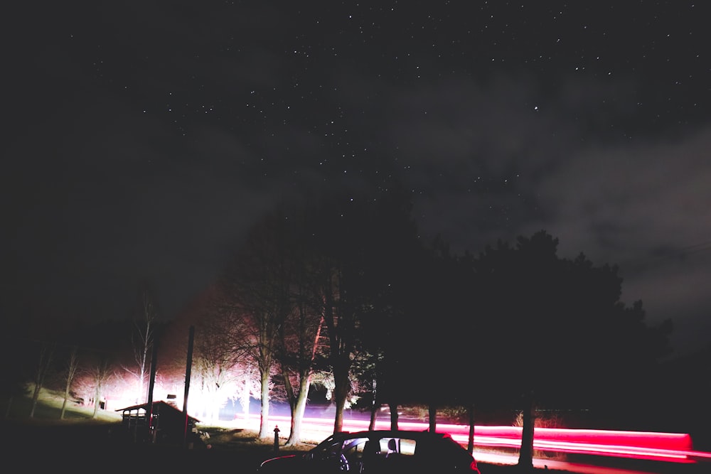 a car driving down a road at night