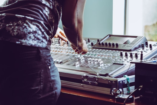 photo of person adjusting audio mixer
