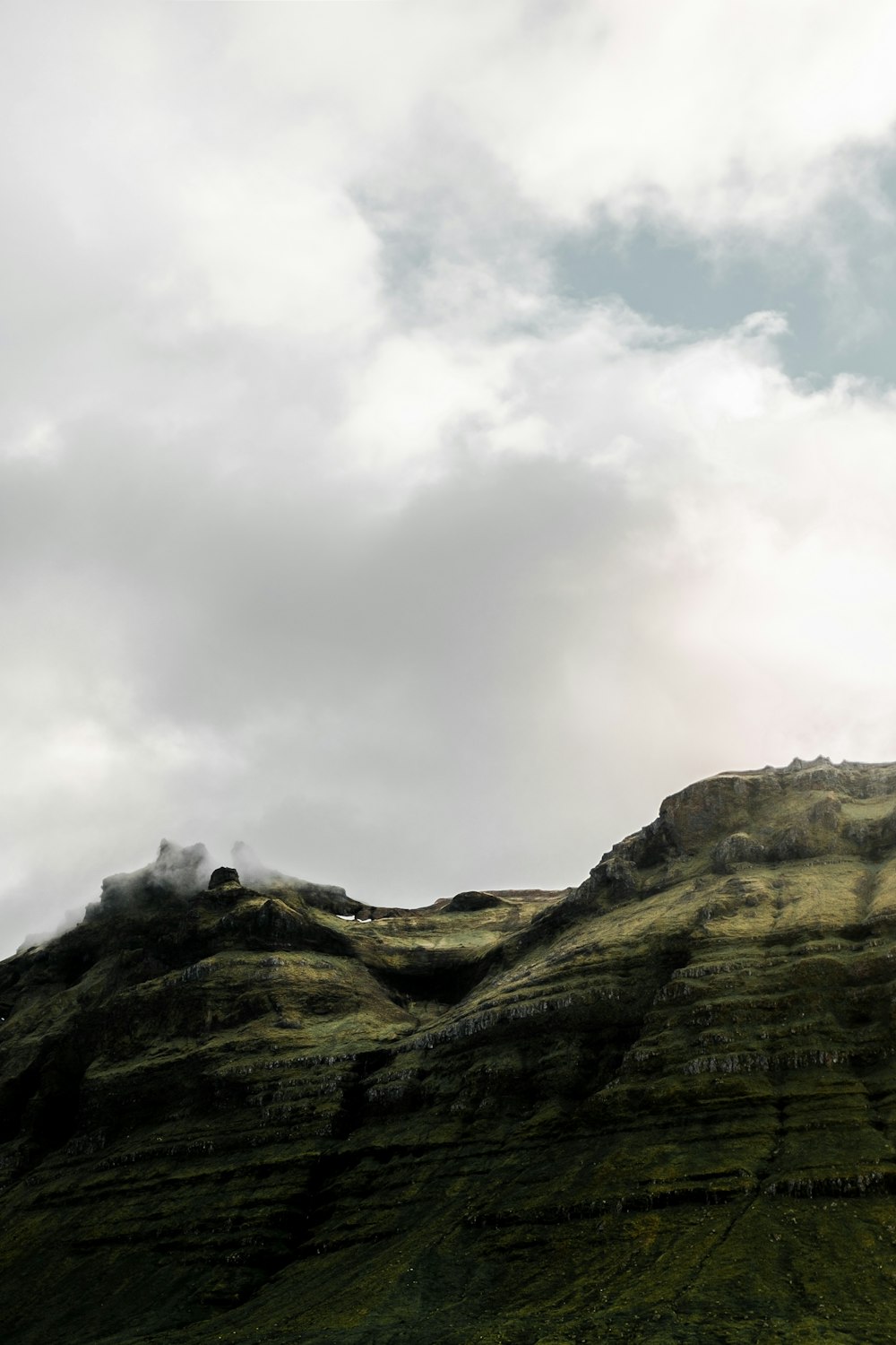 mountain under cloudy sky during daytime