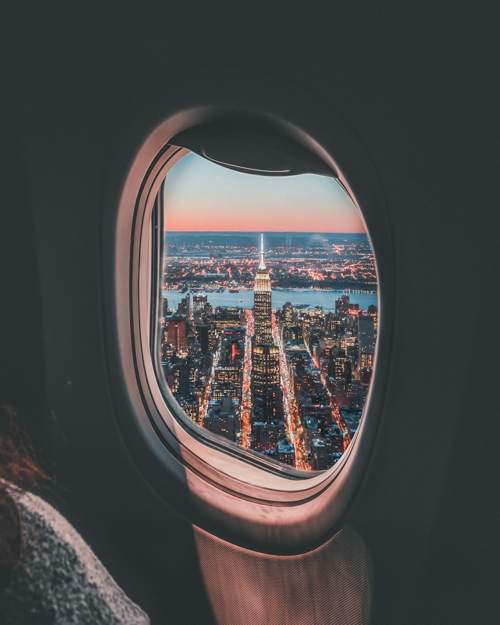 plane window photo of Empire State Building