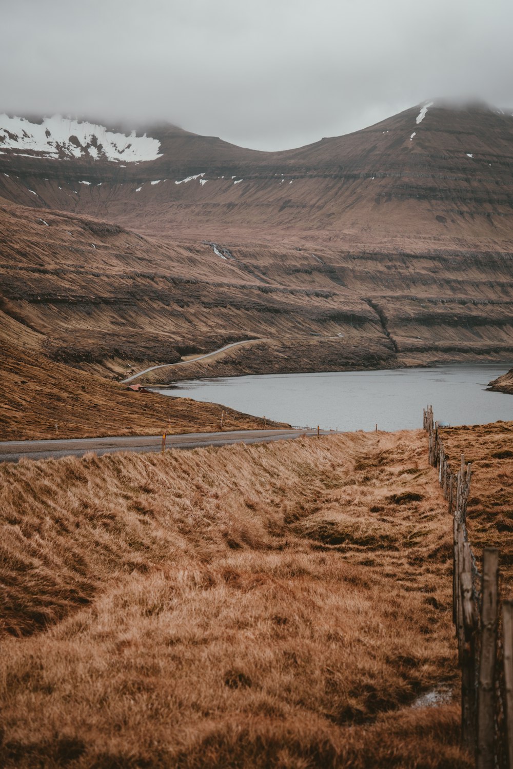 photo of body of water near mountain