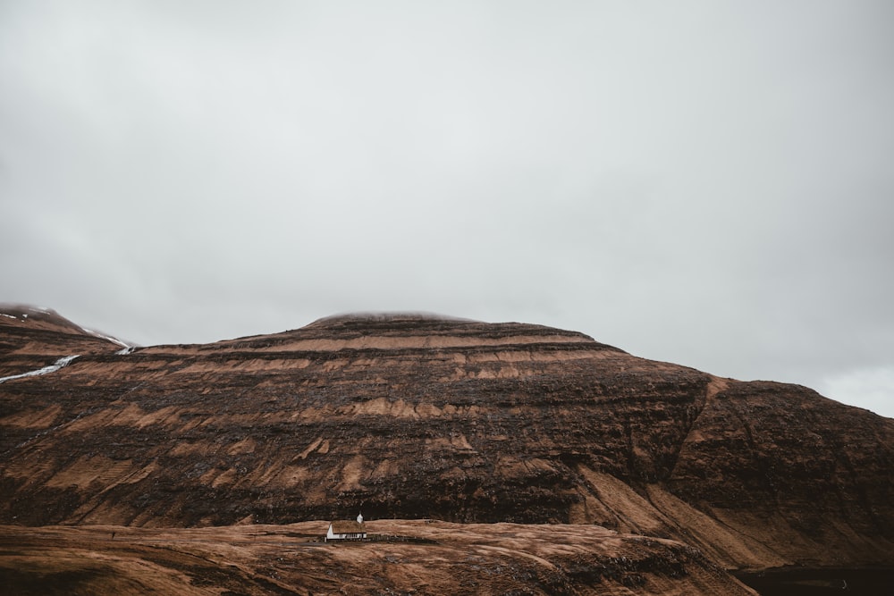 a hill with a small house on top of it