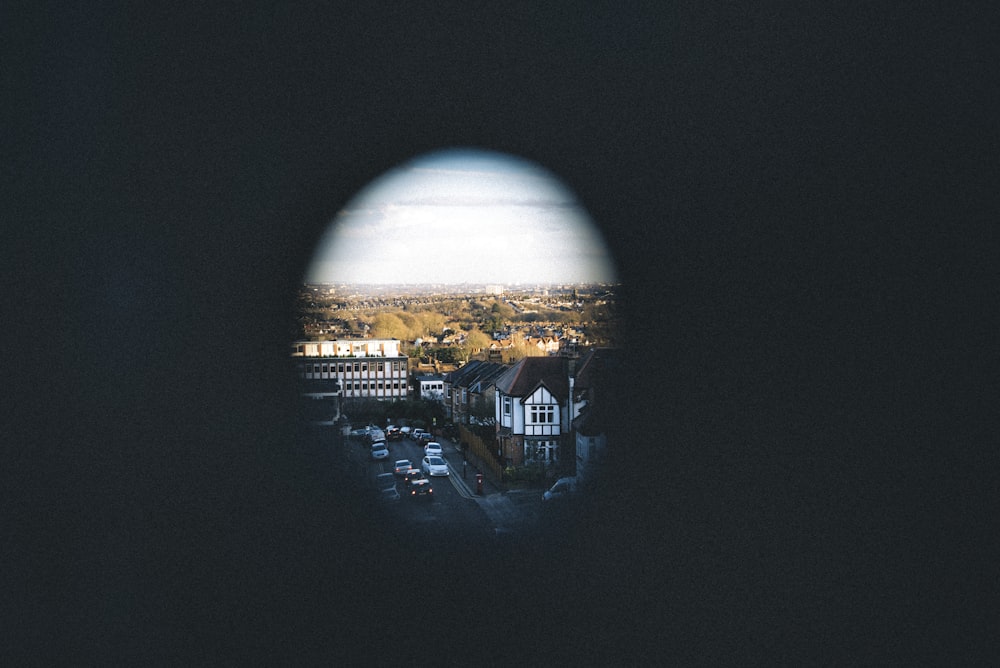 hole photography of village during blue sky