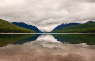 A crystal-clear lake reflecting untouched nature, perfect for a peaceful pause.